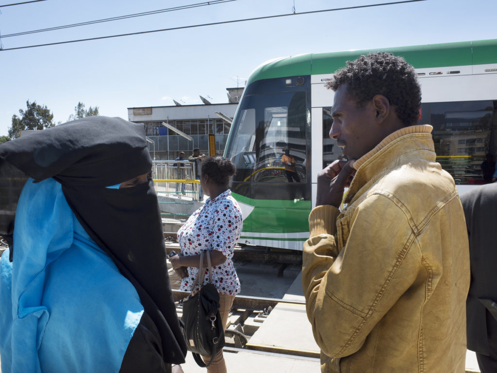  A muslim couple and other passengers wait on tramway station in Addis Ababa, Ethiopia - 2015 